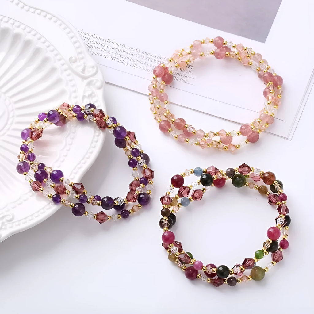 Three-ring crystal bracelet with tourmaline, strawberry quartz and amethyst stones on adjustable tightening rope