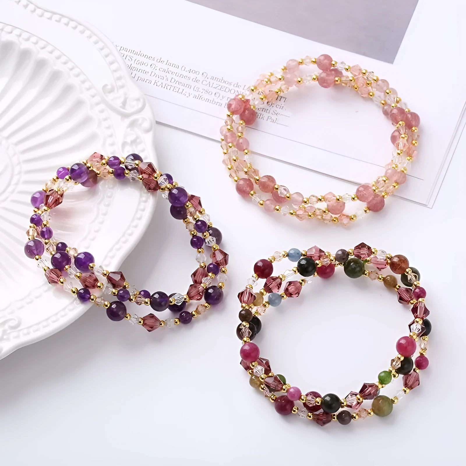 Three-ring crystal bracelet with tourmaline, strawberry quartz and amethyst stones on adjustable tightening rope