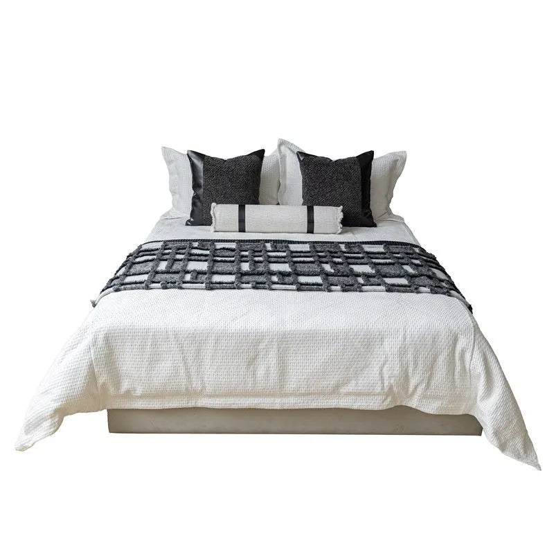 Modern minimalist bed runner nap blanket set with grey and white plaid pattern on bed