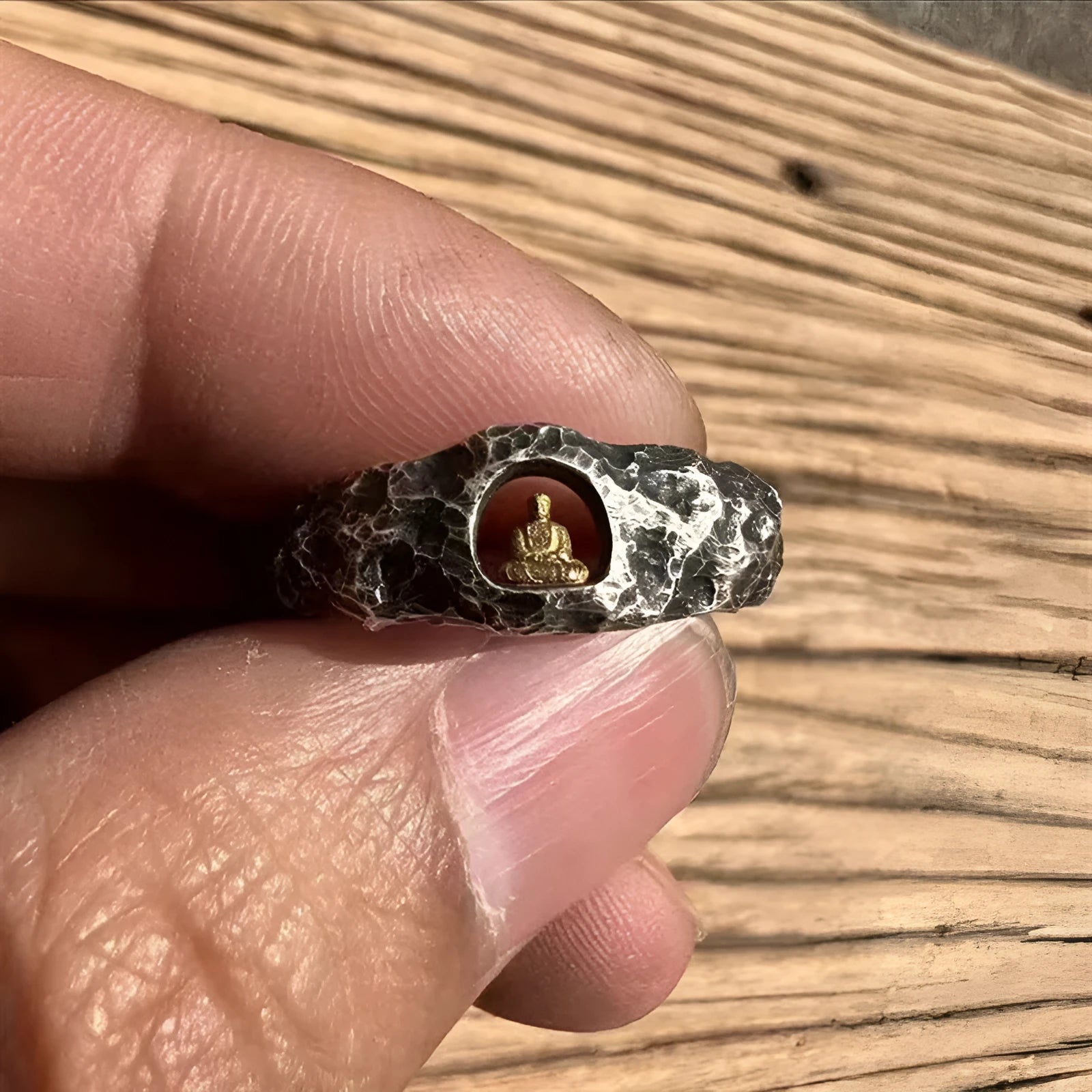 Copper Buddha ring with rock texture surface showing hand-forged details and Buddhist imagery