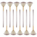 Ten champagne-coloured facial fan brushes with acrylic handles and protective covers laid out.