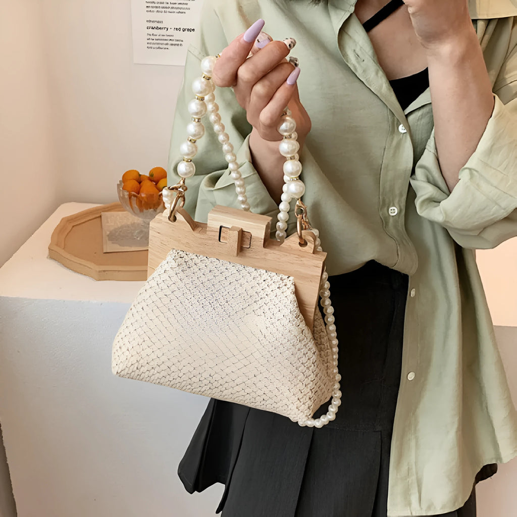 Women's woven straw shoulder bag with pearl chain detail in beige colour, showing interior organiser pockets.