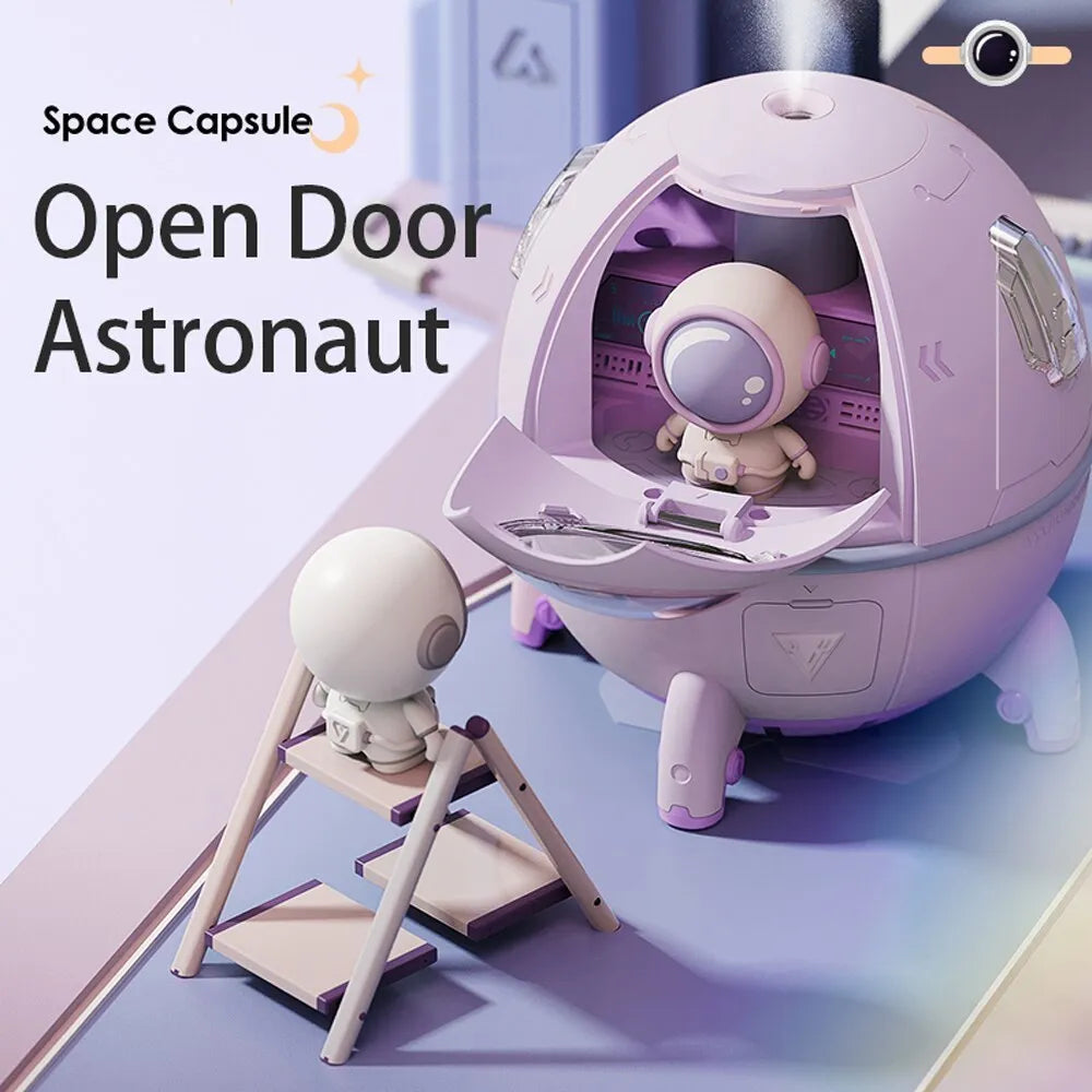 Purple astronaut-shaped USB desktop humidifier with colourful LED light on a desk