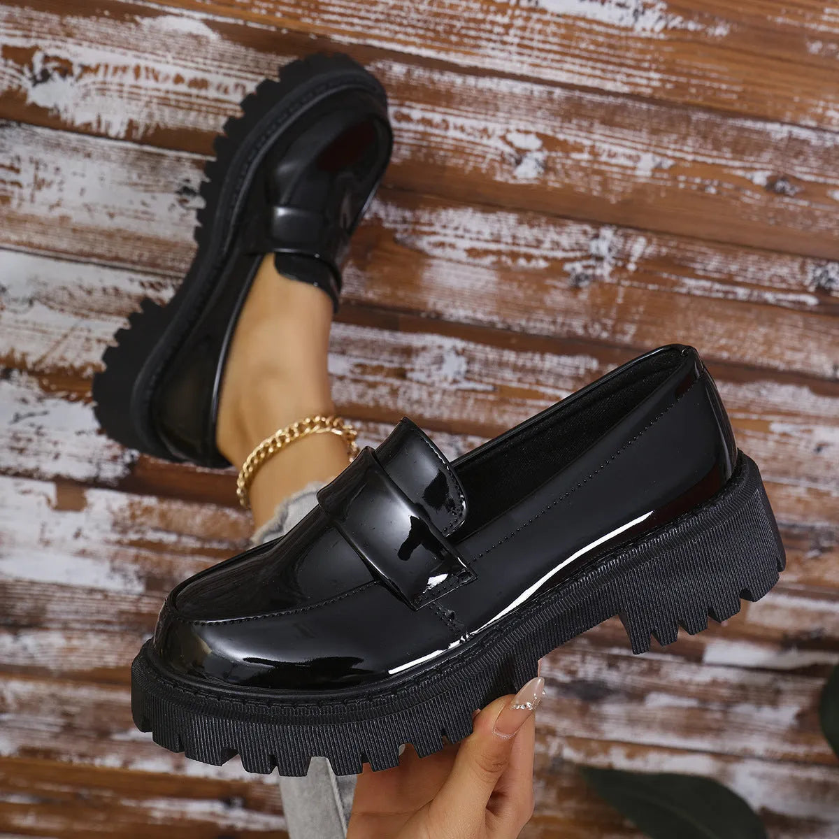 Plus size black slip-on loafers with a chunky platform heel and thick rubber sole.
