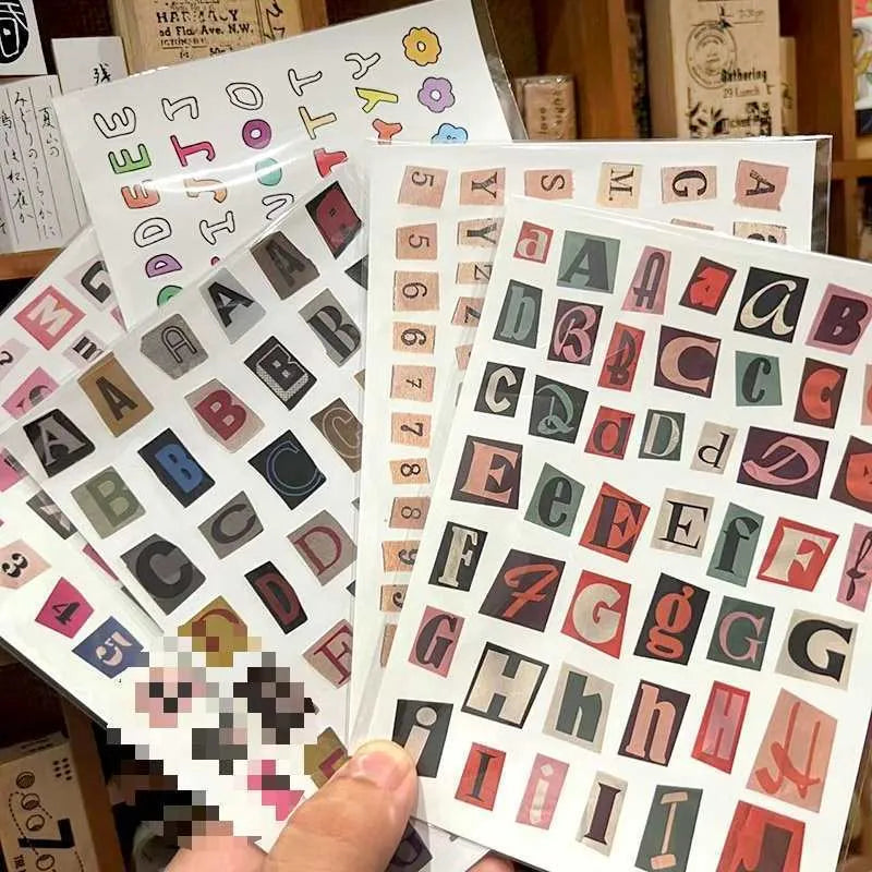 Set of printed English letter, number, and weekly word decoration stickers in assorted colours, laid out flat.