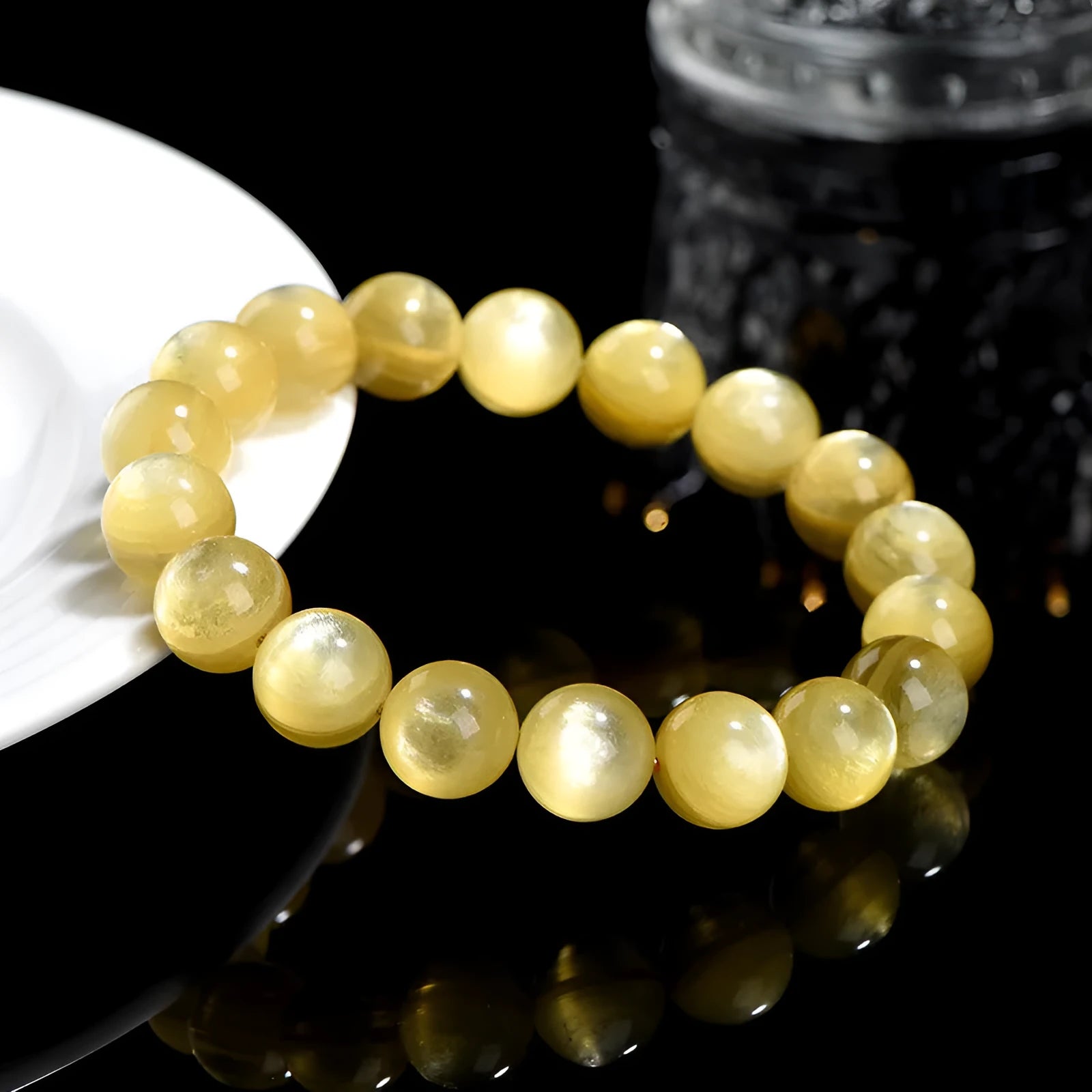 Yellow Lepidolite mica stone bead bracelet with round geometric design on wrist