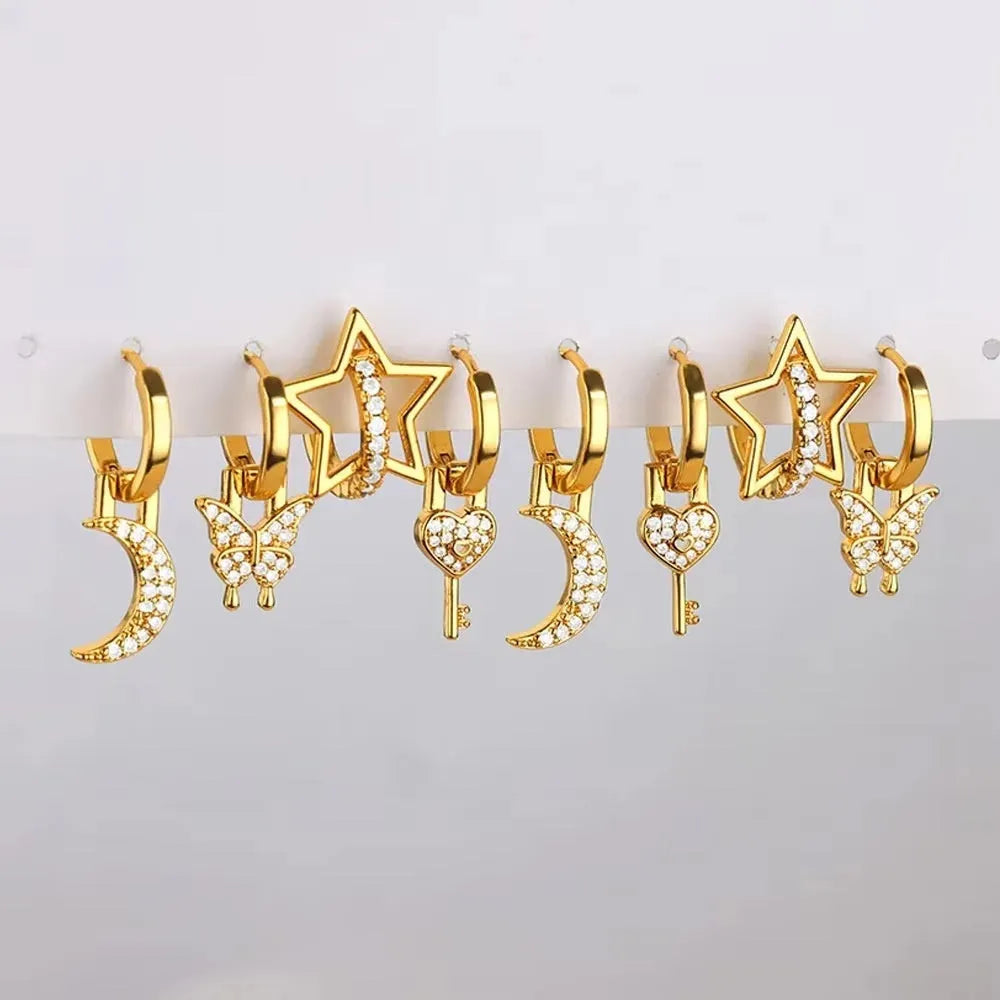Geometric butterfly-shaped earrings with heart, bow, and star details in copper with a diamond-cut finish.