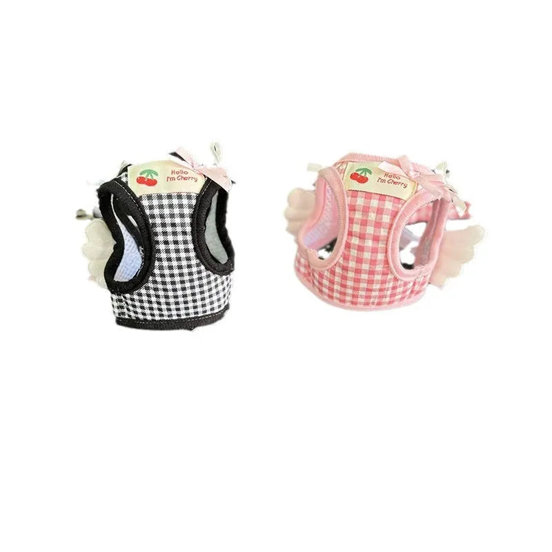 Pink and black small dog harnesses with a hand-holding rope connected at chest and back points.