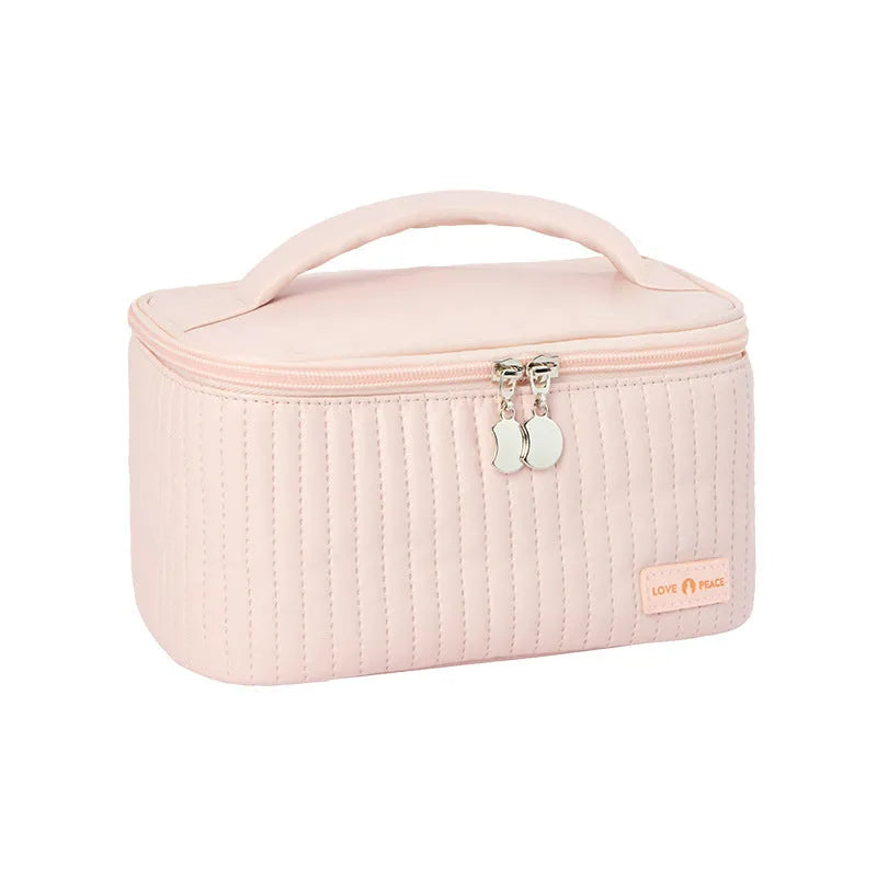 Open-top cake shaped makeup bag in solid colour PU leather, shown in a light blue colour variant.
