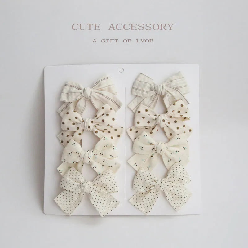 Children's fabric bow hairclips set showing dovetail design in multiple colour options
