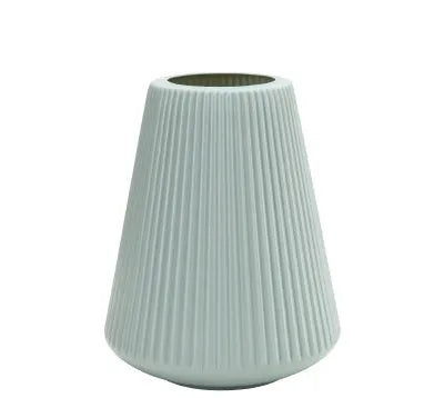 Melamine plastic flower vase in blue colour on desktop with white flowers