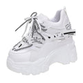 Women's white and black mesh platform sports shoes with cross-strap detail and rubber soles