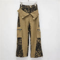 Women's dark khaki high waist straight leg jeans with a leopard print pattern and tooling style stitching detail.
