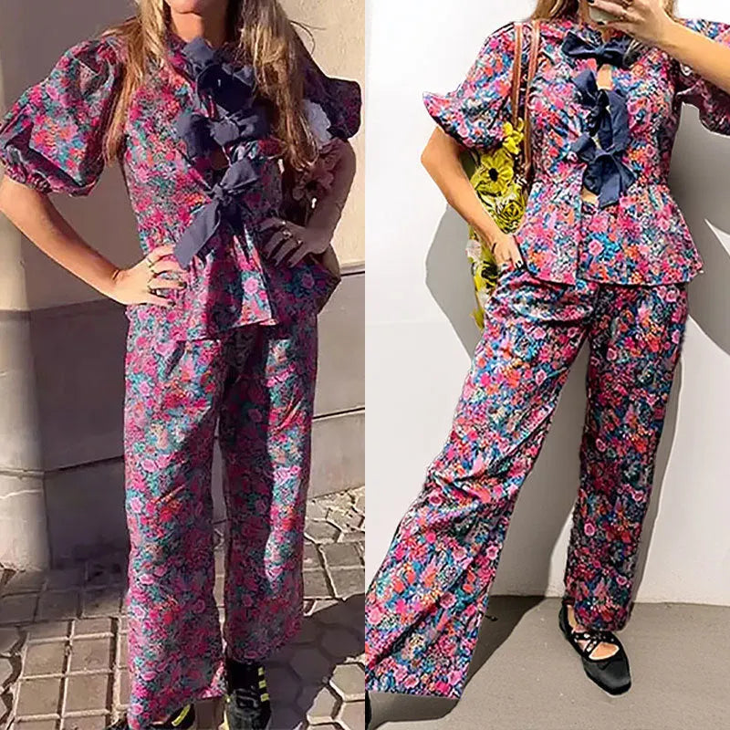 Women's floral print tie-neck trouser suit with puff sleeves, shown in the picture colour.