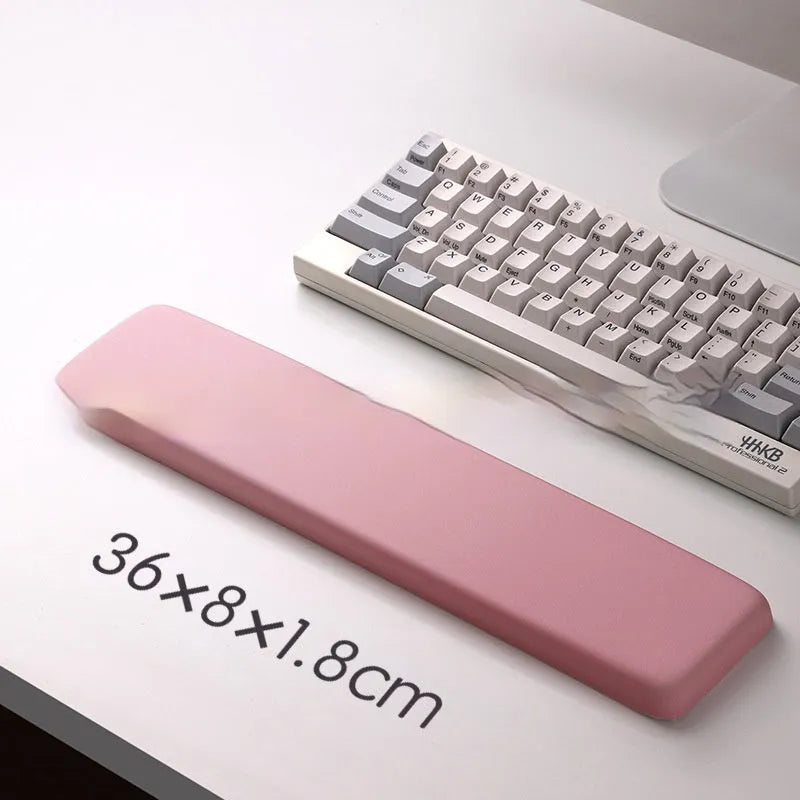 Square black silica gel wrist rest mouse pad with cloth surface on a desk.