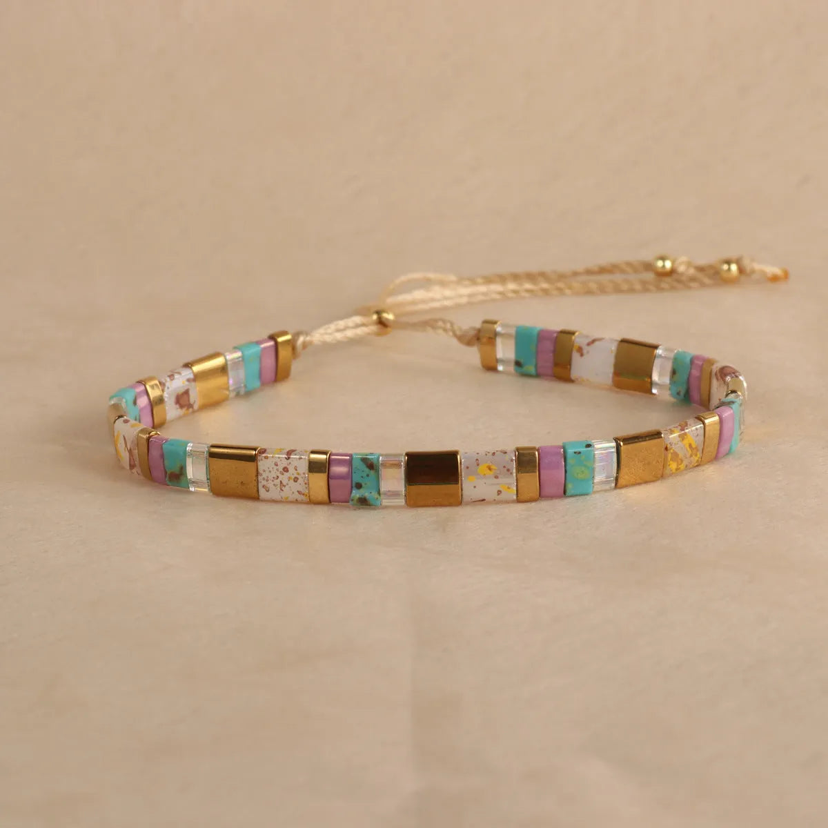 Geometric glass pull bead bracelet in five colour options on wrist