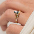 Gold plated floral pattern ring with green zircon stone inlay on woman's finger