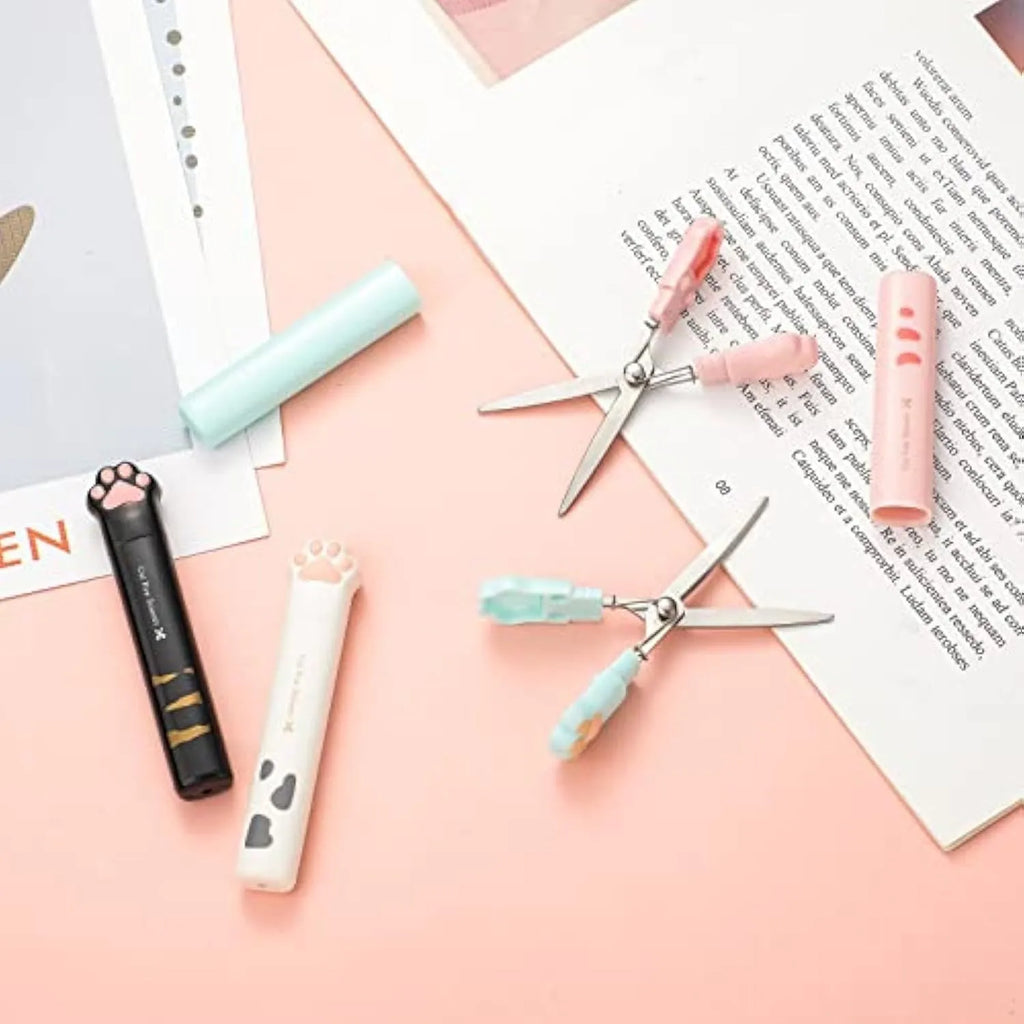 Folded cat paw mini scissors in stainless steel and plastic available in pink blue black and white colours measuring 8.7cm