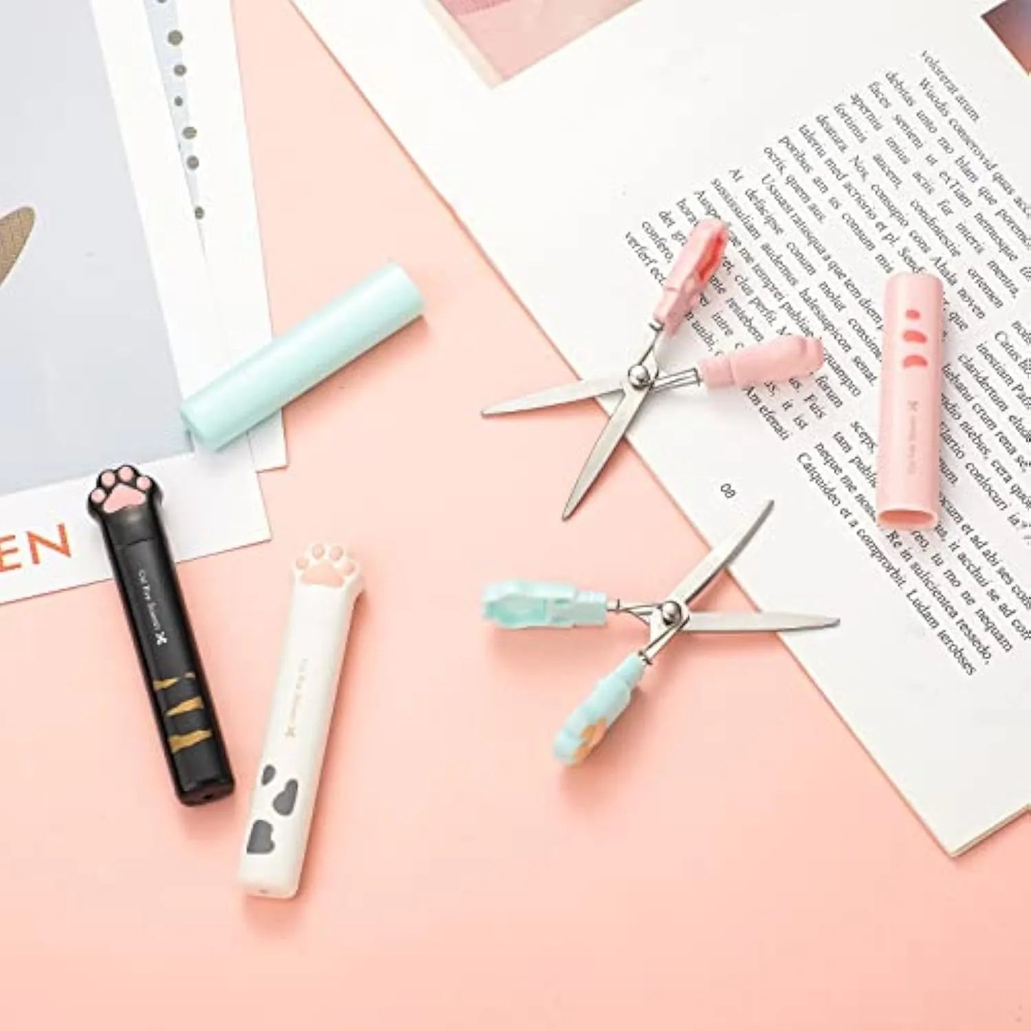 Folded cat paw mini scissors in stainless steel and plastic available in pink blue black and white colours measuring 8.7cm
