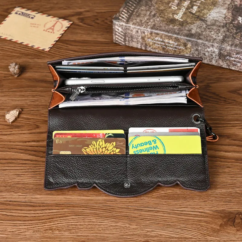 Brown genuine leather tri-fold wallet with embossed floral pattern, shown open to display compartments.
