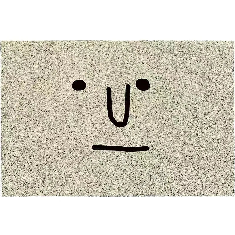 Square PVC floor mat with a cartoon facial expression and geometric pattern in Mr. Big Nose colour.