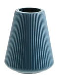 Melamine plastic flower vase in blue colour on desktop with white flowers