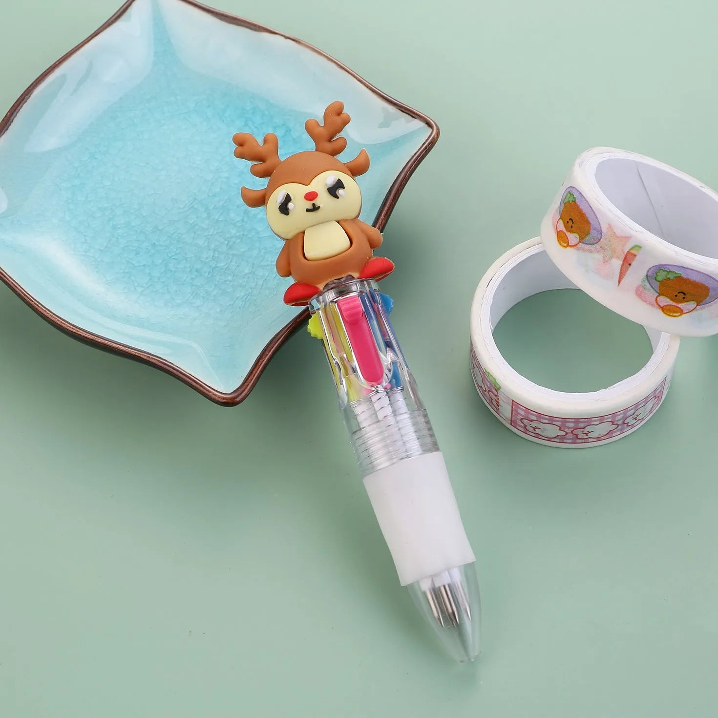 Compact 11cm Christmas four-colour press pen with festive designs including reindeer and snowmen.