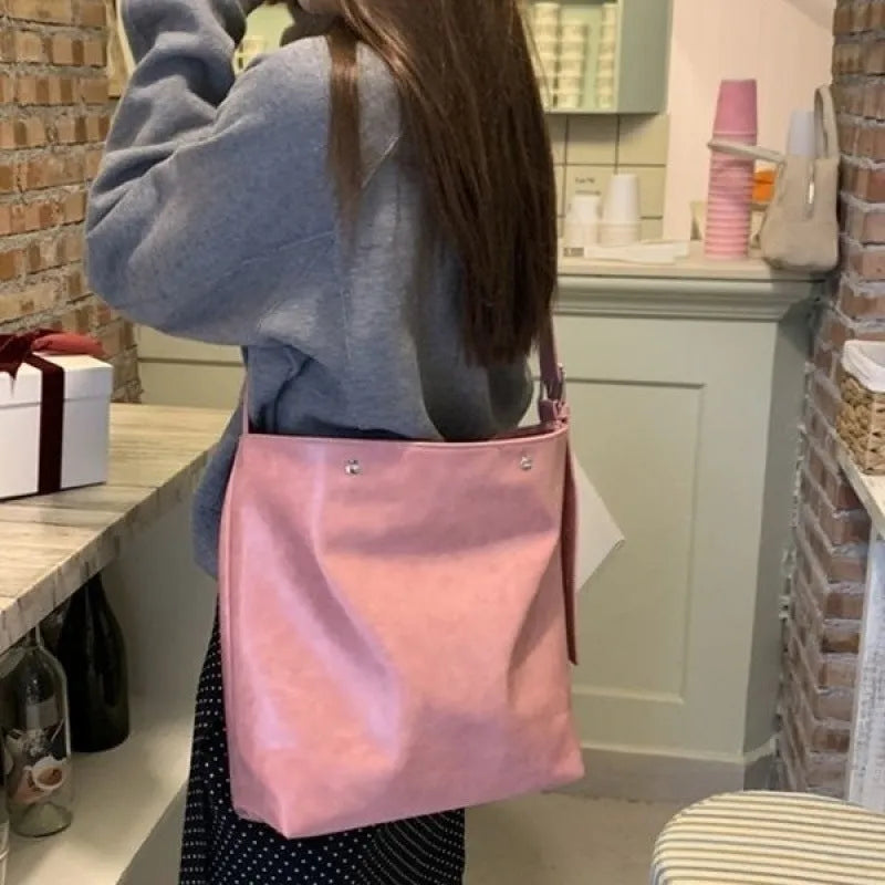 Corduroy one-shoulder commuter bag in pink colour showing textured fabric and structured design