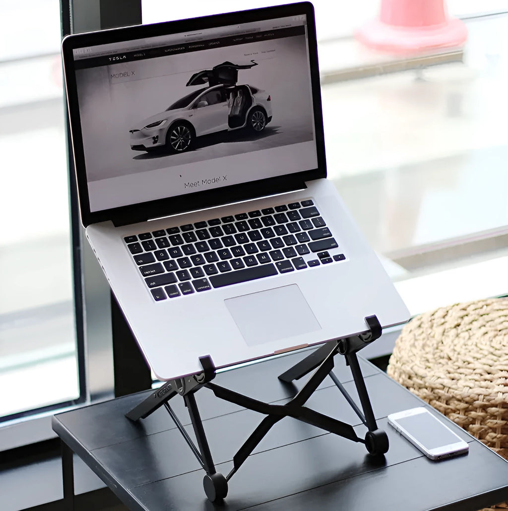 Black folding portable laptop stand made of reinforced nylon, shown both open for use and folded flat.