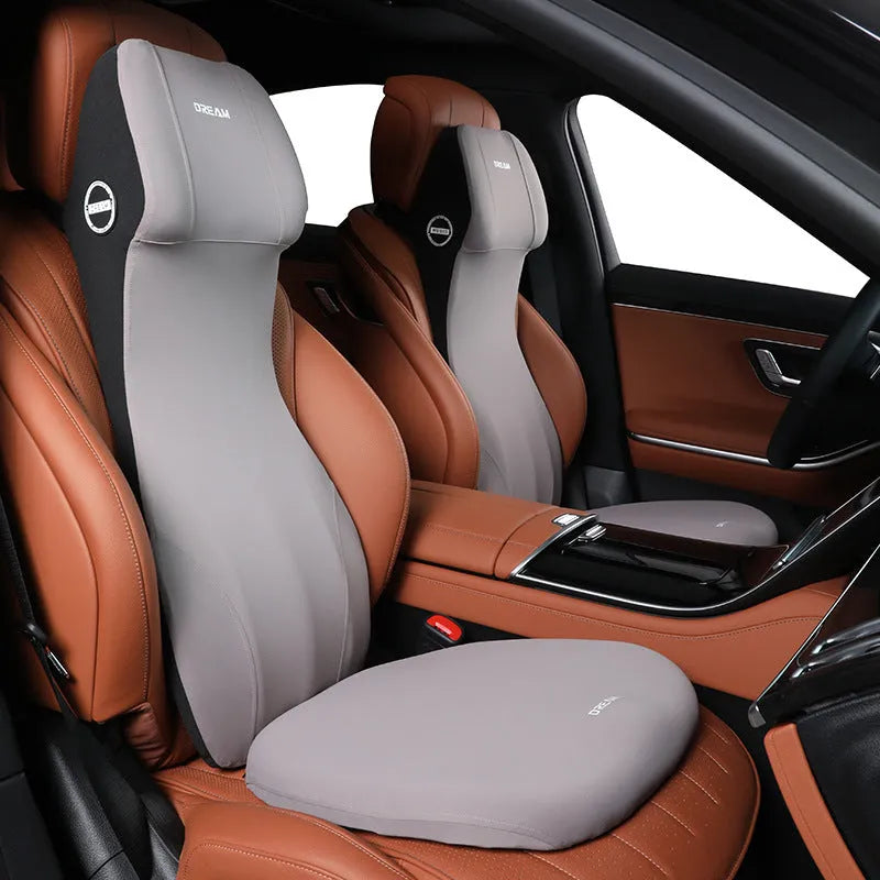 Integrated automotive memory foam seat cushion and headrest lumbar support pillow in various colours.