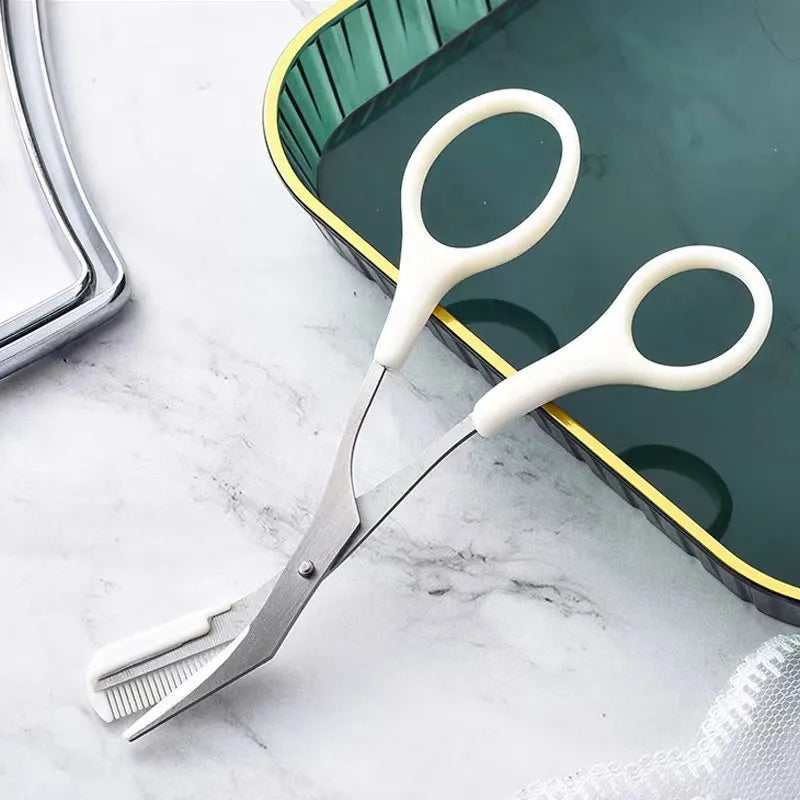 Close-up of a white and pink eyebrow trimming knife with a small curved plastic comb on a plain background.