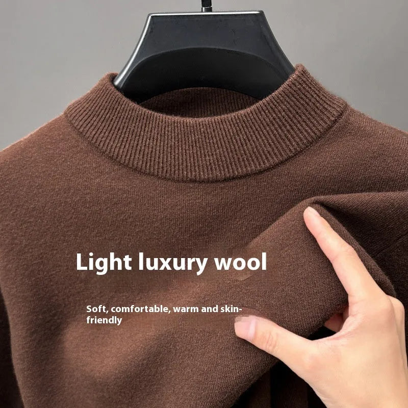 Man wearing a solid colour half turtleneck long sleeve jumper in a casual setting.
