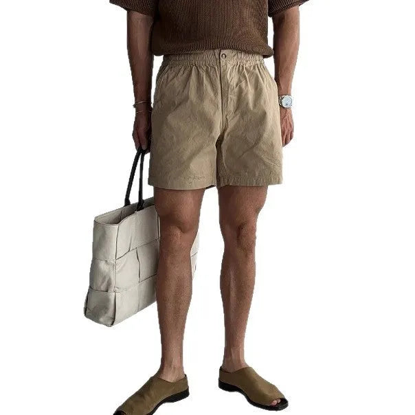 Men's loose-fit cotton sports shorts in black, shown on a white background