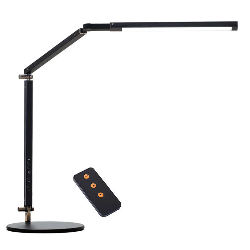 Black adjustable clip-on desk lamp with flexible arm and remote control on a wooden desk