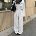 White striped wide-leg casual trousers with a front zip closure, shown in a loose fit.
