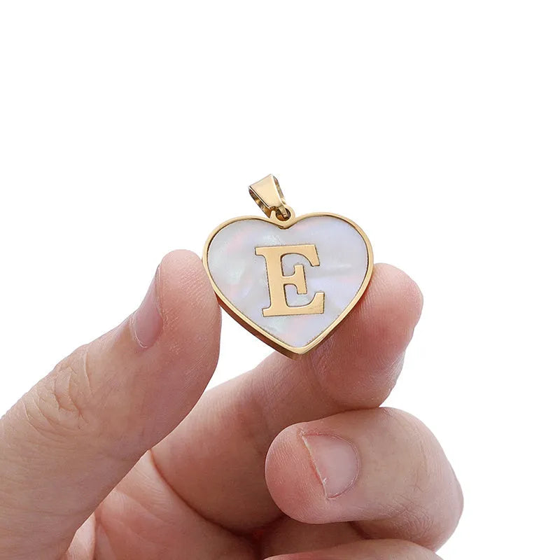 Gold plated heart-shaped white shell pendant personalised initial necklace on a stainless steel chain.