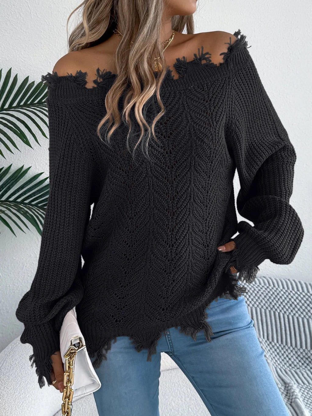 White hollow-out cut-off shoulder pullover sweater with long sleeves on hanger