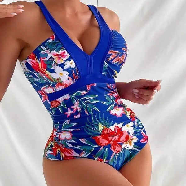 Women's floral print backless one-piece swimsuit on a mannequin.