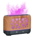 Christmas snowflake pattern humidifier with colourful flame effects and remote control on wooden desk