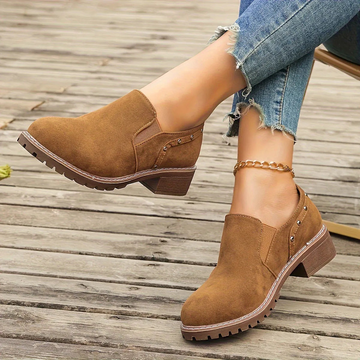 Women's light brown suede ankle boots with a thick low heel and elastic band fastening.