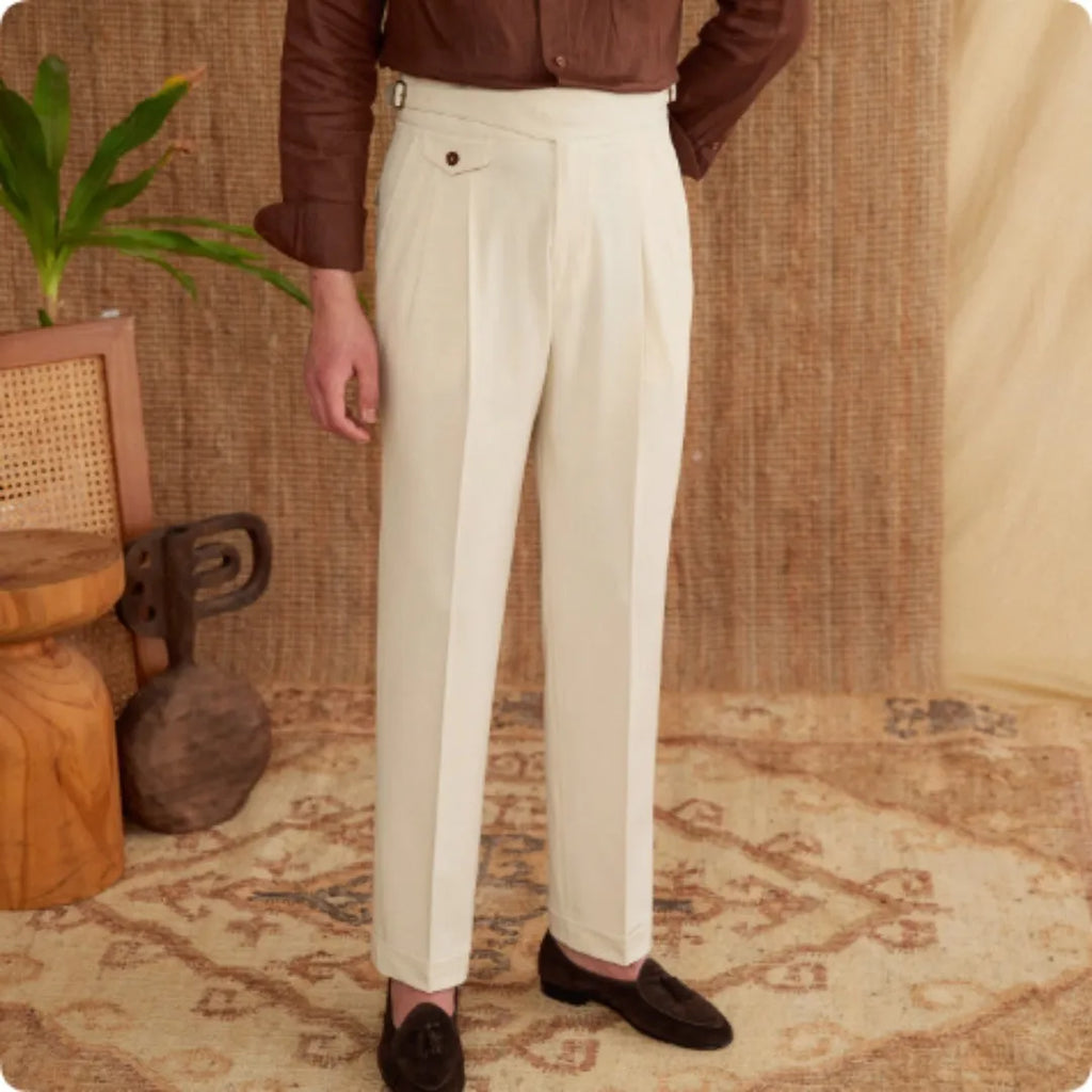 Men's slim fit straight leg trousers in dark grey, light brown, and light apricot colours on a hanger.