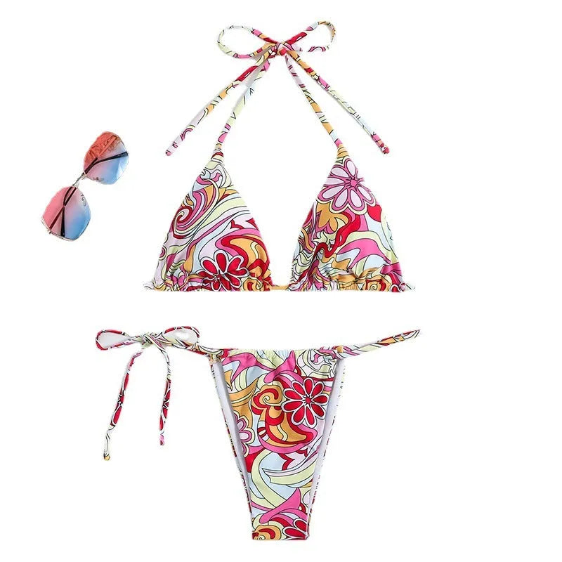 Multicolour printed women's triangle bikini set with hanging neck top and separate bottoms.