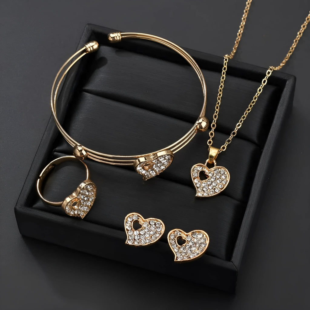 Gold jewellery set with earrings, pendant and adjustable bracelet showing love, water drop and bell motifs