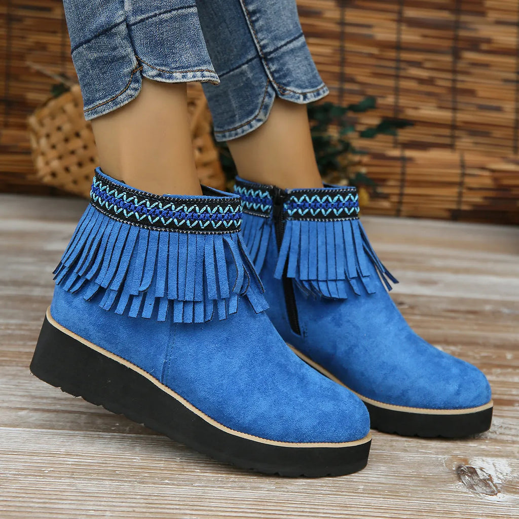 Womens dark brown suede wedge ankle boots with side zip and tassel detail on a thick rubber sole.