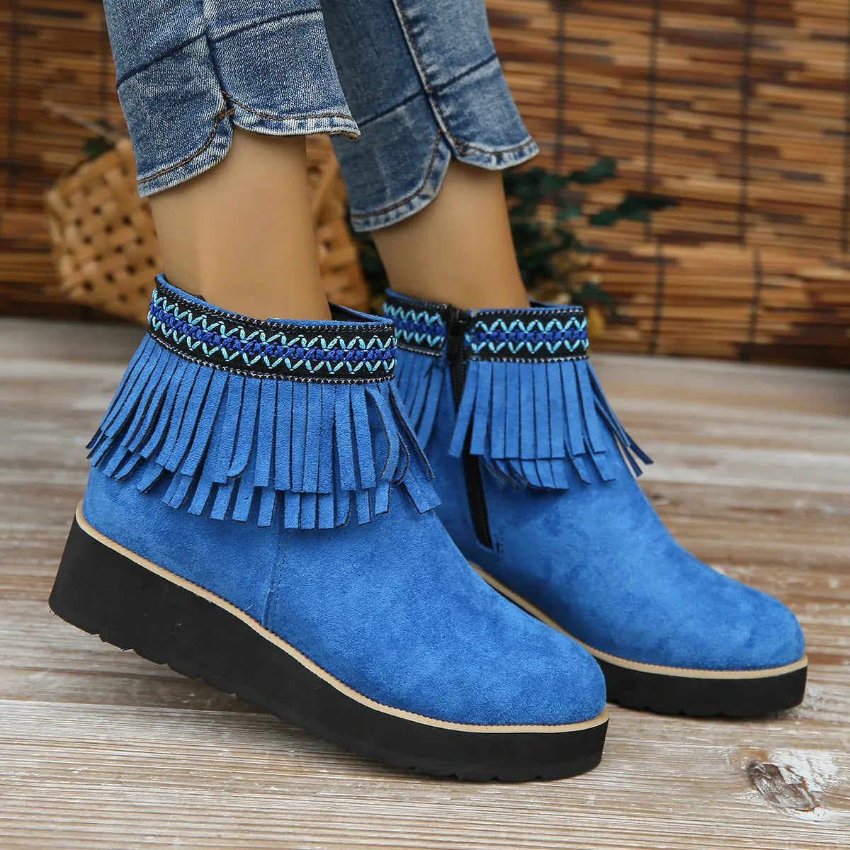 Womens dark brown suede wedge ankle boots with side zip and tassel detail on a thick rubber sole.