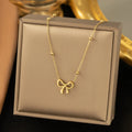 Gold bow necklace with cross chain links and adjustable 41-50cm length