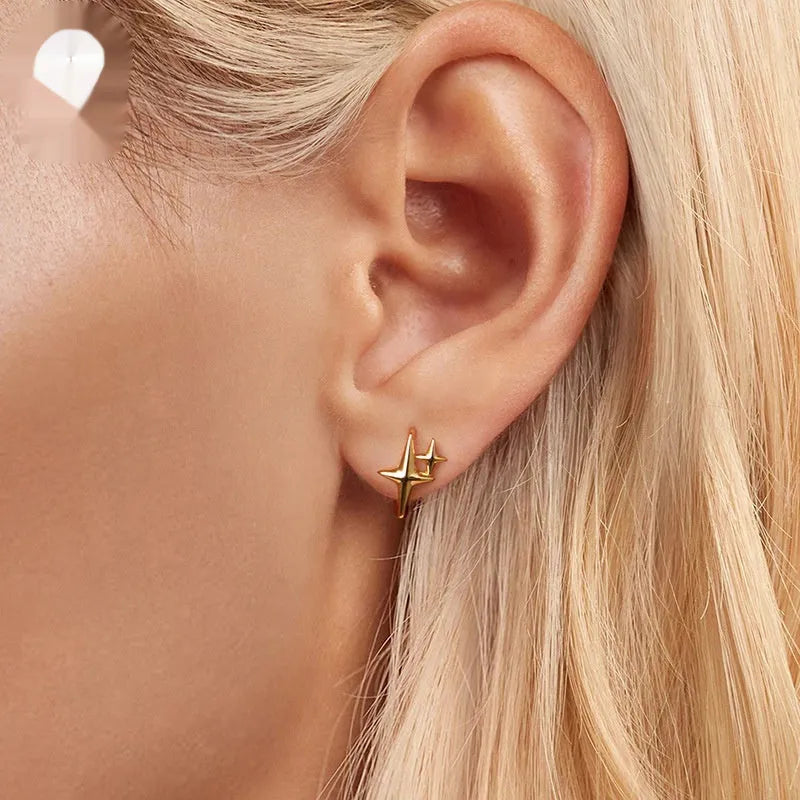 Minimalist sterling silver star ear clips with oxidised finish and ear clip design
