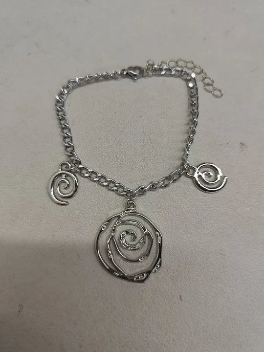 Spiral donut jewellery set showing gold tone necklace, bracelet and earrings with geometric circular design