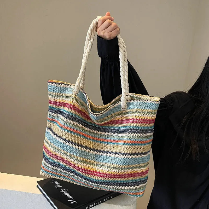 Blue woven straw shoulder bag with traditional weaving patterns and single shoulder strap