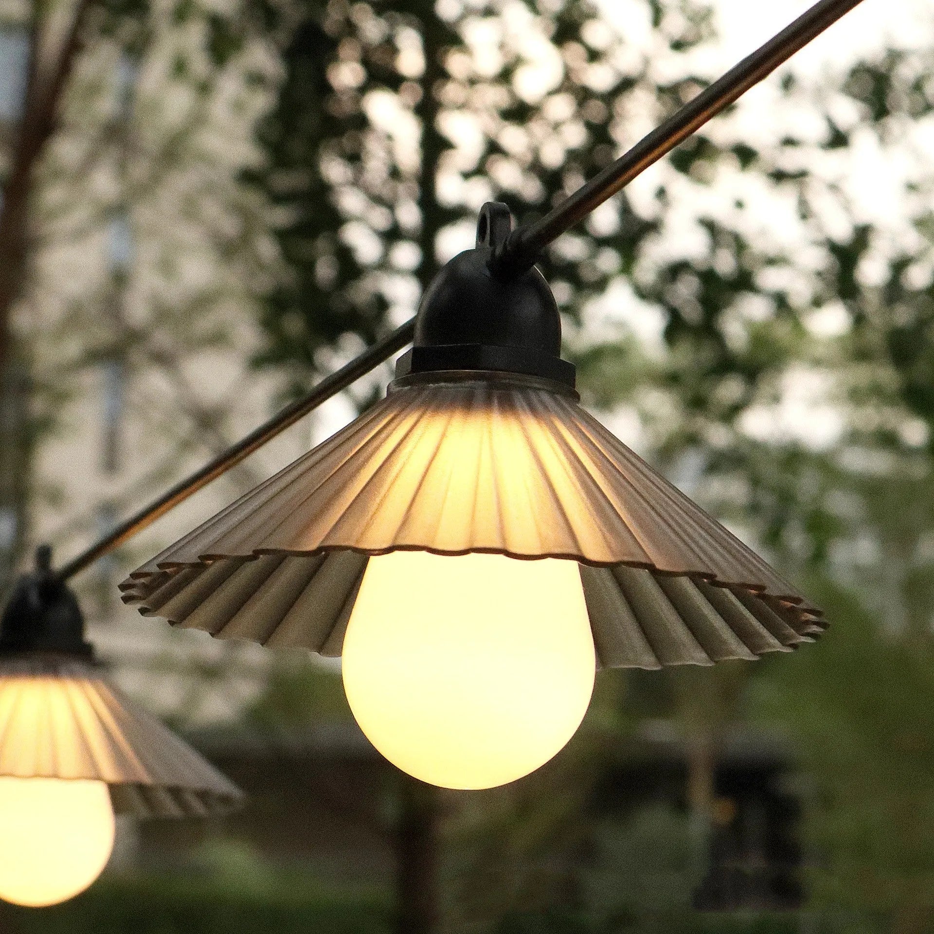 Outdoor waterproof LED string lights with flower-shaped globes in warm white and multi-colour options.